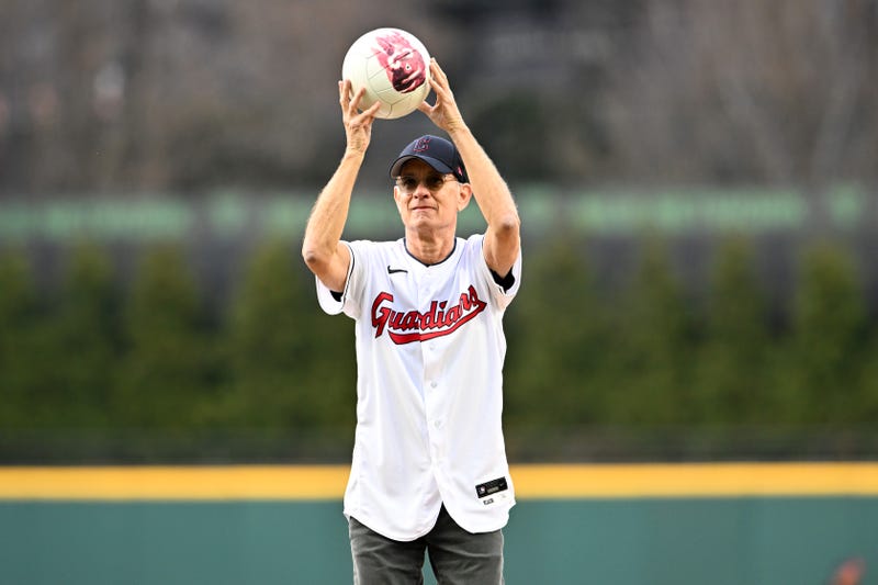 CLEVELAND, OHIO - APRIL 15: Actor and Cleveland Guardians fan Tom Hanks holds his co-star Wilson before throwing out the ceremonial first pitch prior to the home opener against the San Francisco Giants at Progressive Field on April 15, 2022 in Cleveland, Ohio. All players are wearing the number 42 in honor of Jackie Robinson Day. (Photo by Jason Miller/Getty Images)