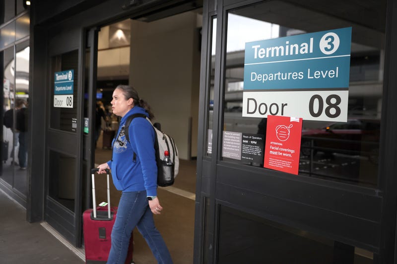 A sign stating that masks are required at San Francisco International Airport is posted on a terminal door after the federal mask mandate for airports and pubic transportation was lifted on April 19, 2022 in San Francisco, California.