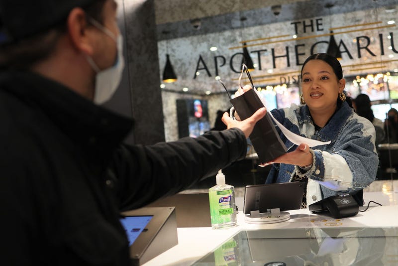 A customer receives their order from an employee at Apothecarium Dispensary on April 21, 2022 in Maplewood, New Jersey.