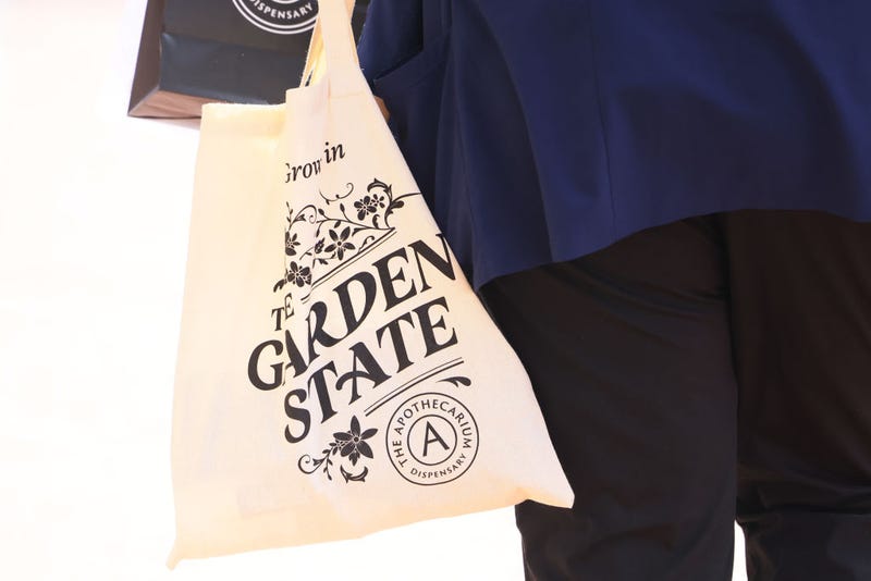 A customer carries their order after leaving Apothecarium Dispensary on April 21, 2022, in Maplewood, New Jersey.