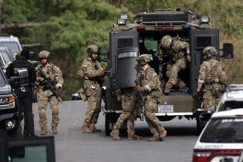 WASHINGTON, DC - APRIL 22: Law enforcement officers climb out of an armored vehicle as they arrive at the scene of a shooting on April 22, 2022 in Washington, DC. Police evacuated residents from the shooting scene Friday afternoon and there were reports of several shooting victims.