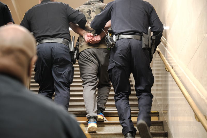 Police detain a man at a Times Square subway station following a call to police from riders on April 25, 2022 in New York City