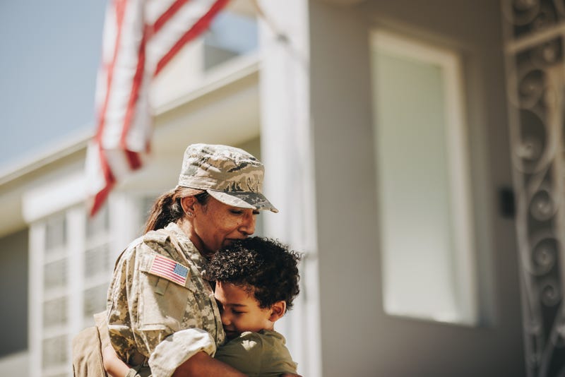 mom soldier hugging her little son