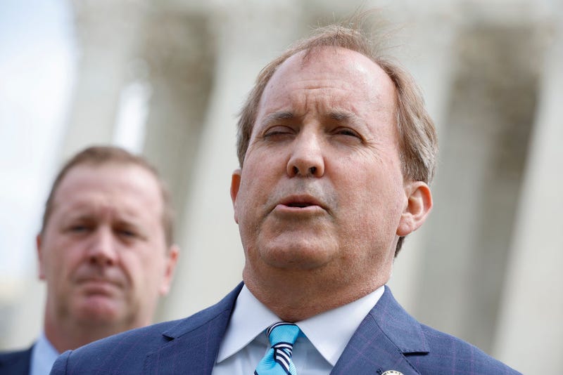 Texas Attorney General Ken Paxton (R) and Missouri Attorney General Eric Schmitt talk to reporters after the U.S. Supreme Court heard arguments in their case about Title 42 on April 26, 2022 in Washington, DC.