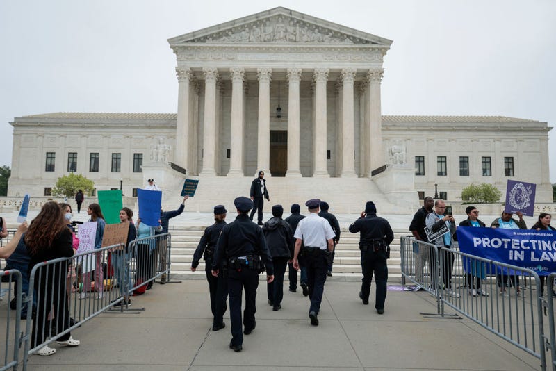 U.S. Supreme Court police officers set up barricades on the sidewalk as pro- and anti-abortion activists demonstrate in front of the U.S. Supreme Court building on May 3, 2022, in Washington, D.C. 