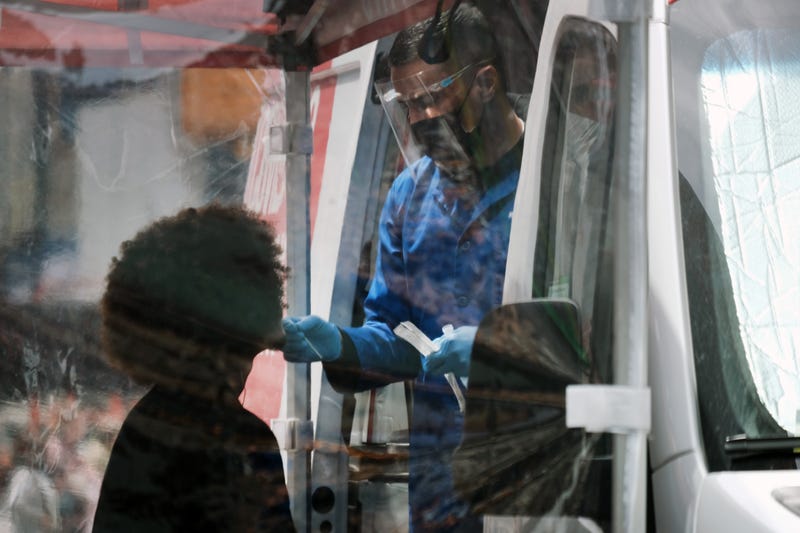 A person is tested at a Covid-19 testing van in Times Square on May 03, 2022 in New York City. Health officials announced on Monday that New York City will raise its COVID alert level to medium as cases have surpassed a rate of 200 per 100,000 people in the five boroughs.