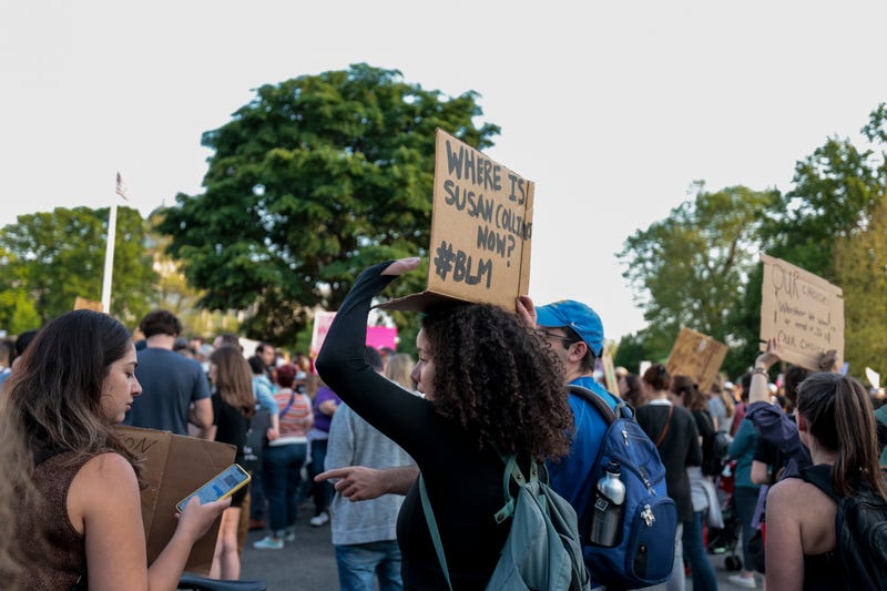 A pro-choice demonstrator holds up a sign as they attend an abortion rights rally at the U.S. Supreme Court Building