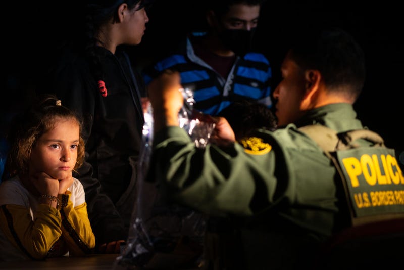  A child watches as a border patrol officer processes her family's belongings after they crossed the Rio Grande into the U.S. on May 05, 2022 in Roma, Texas. Texas Gov. Greg Abbott's "Operation Lone Star" directed approximately 10,000 members of the National Guard to assist law enforcement with patrol and border apprehensions. The operation is expected to receive another $500 million to further secure the southern border. Towns along the border continue making preparations as Title 42 is scheduled to end on May 23rd. (Photo by Brandon Bell/Getty Images)