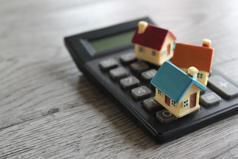 Houses on a calculator depicting affordable housing.