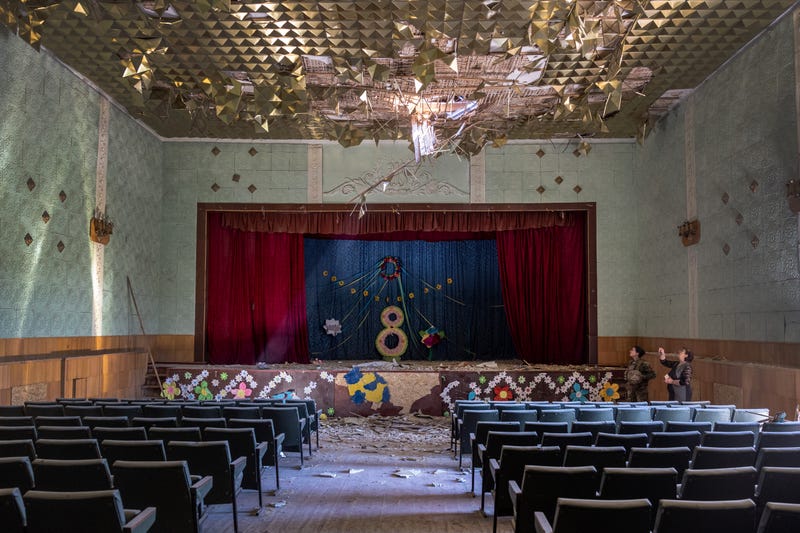 Ukrainian Army Lt. Karyna Skubak, 24, and village leader Dina, 62 inspect a bomb-damaged auditorium in a town which was, until recently, partially occupied by Russian forces in Kherson Oblast on May 08, 2022 in Zagradivka, Ukraine.