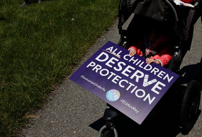 A child is seen with a sign during a demonstration urging the Food and Drug Administration to authorize vaccines for children under 5 at the FDA on May 09, 2022 in Washington, DC.