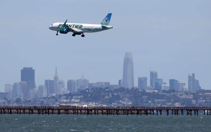 A Frontier Airlines plane lands at San Francisco International Airport on May 12, 2022 in San Francisco, California.