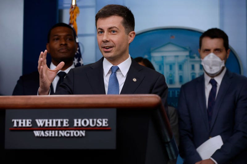 Transportation Secretary Pete Buttigieg (C) speaks during a news conference marking six months since the signing of the bipartisan infrastructure bill with Environmental Protection Agency Administrator Michael Regan (L) and National Economic Council Director Brian Deese in the Brady Press Briefing Room at the White House on May 16, 2022 in Washington, DC. 