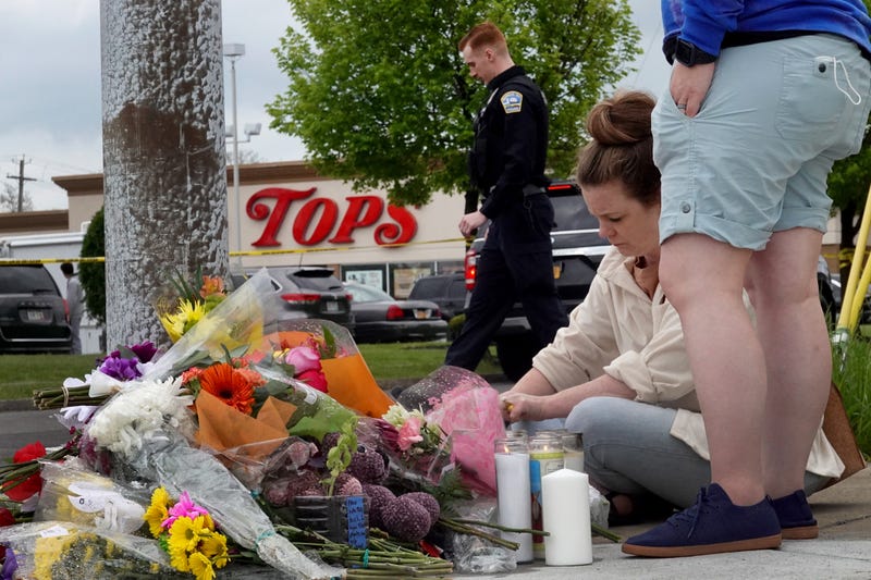 People gather at a memorial outside of Tops market on May 16, 2022 in Buffalo, New York.