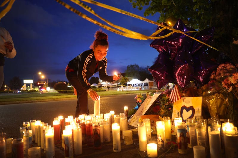 Mourners light candles at a makeshift memorial outside of Tops market on May 16, 2022 in Buffalo, New York.