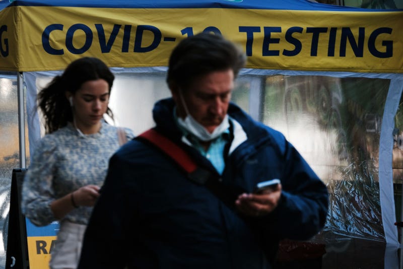 People walk past a Covid testing site on May 17, 2022 in New York City. New York’s health commissioner, Dr. Ashwin Vasan, has moved from a "medium" COVID-19 alert level to a "high" alert level in all the five boroughs following a surge in cases.