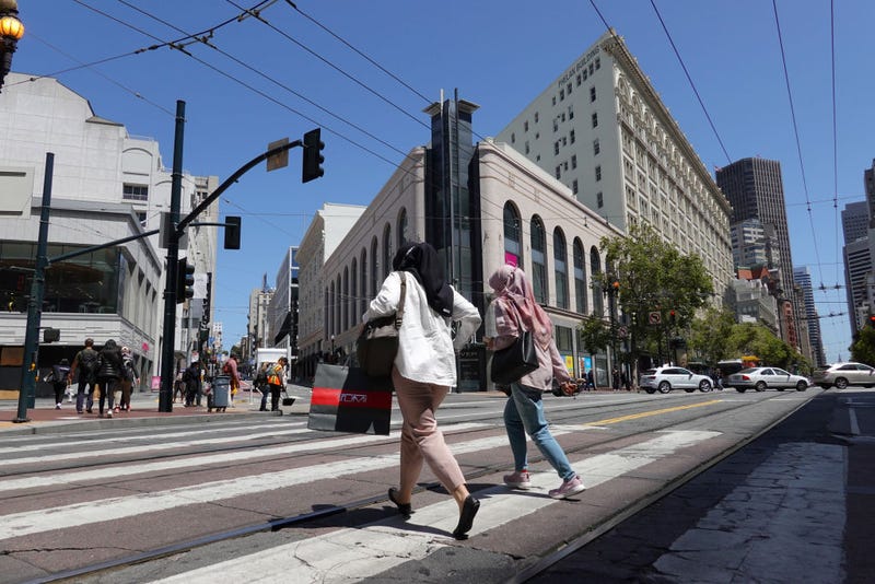 A pedestrian carries a shopping bagwhile walking through Union Square on May 17, 2022 in San Francisco, California.