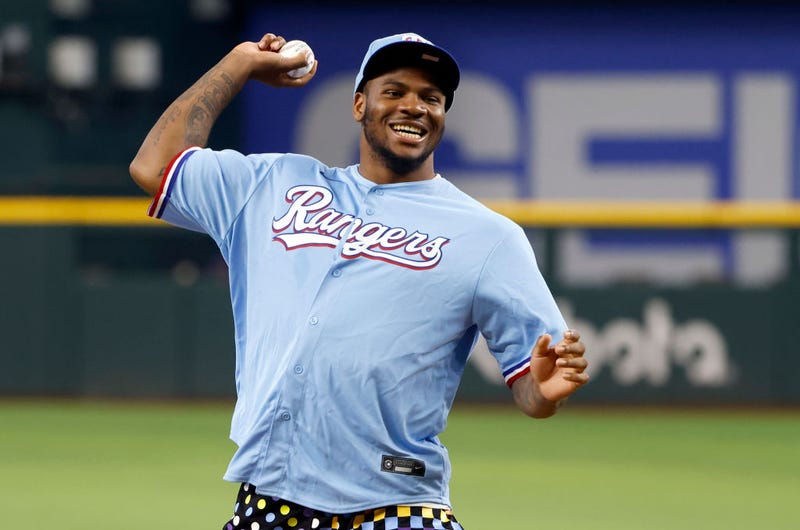 Linebacker Micah Parsons of the Dallas Cowboys throw out the ceremonial first pitch before the Texas Rangers take on the Los Angeles Angels at Globe Life Field on May 17, 2022 in Arlington, Texas.