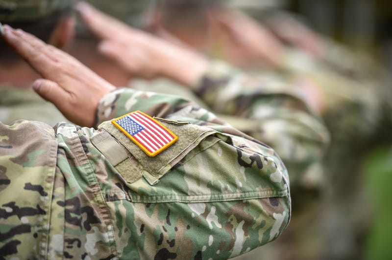 Detail shot with an American flag on soldier uniform.