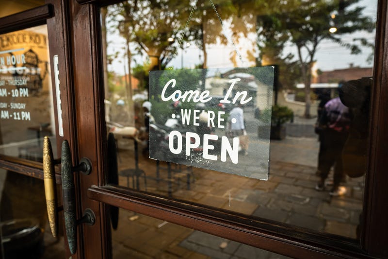 Come in, we are open sign outside a small business