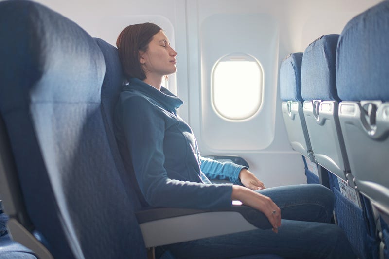 Woman sitting at window of plane during the flight.
