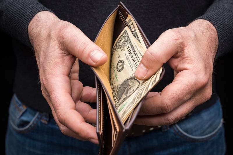 Man with dollar bills in his wallet.