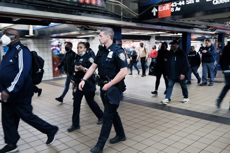 NYPD officers walk through the Port Authority subway station