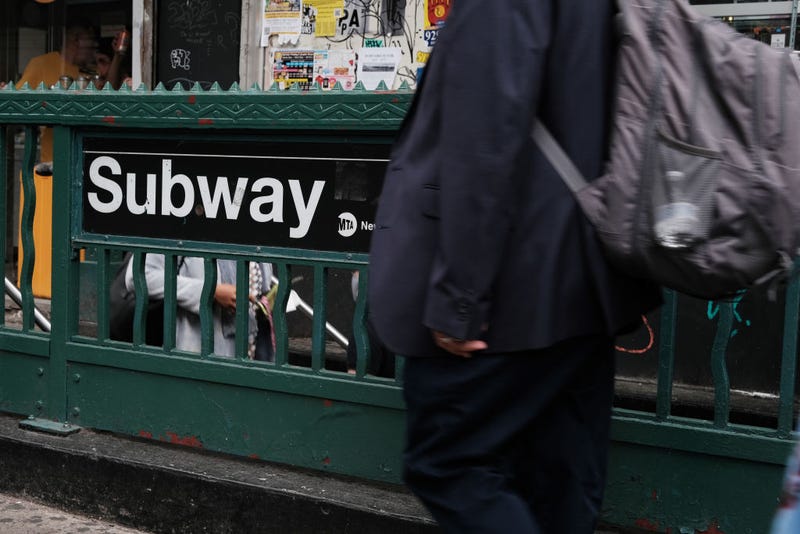  People walk by a Manhattan subway station on May 24, 2022 in New York City. 