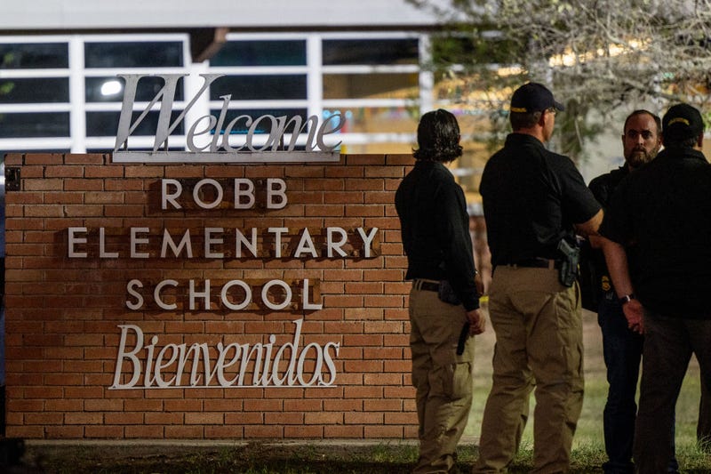 Law enforcement officers speak together outside of Robb Elementary School following the mass shooting at Robb Elementary School on May 24, 2022 in Uvalde, Texas. According to reports, 19 students and 2 adults were killed, with the gunman fatally shot by law enforcement. (Photo by Brandon Bell/Getty Images)