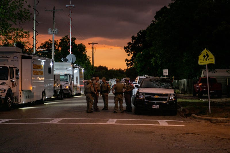 Law enforcement officers speak together outside of Robb Elementary School following the mass shooting at Robb Elementary School on May 24, 2022, in Uvalde, Texas. According to reports, 19 students and 2 adults were killed, with the gunman fatally shot by law enforcement.