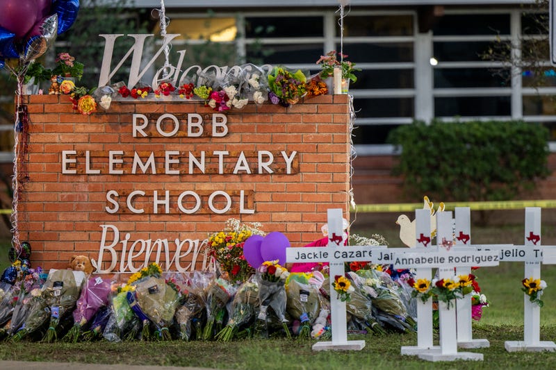 A memorial is seen surrounding the Robb Elementary School sign following the mass shooting at Robb Elementary School on May 26, 2022 in Uvalde, Texas. 