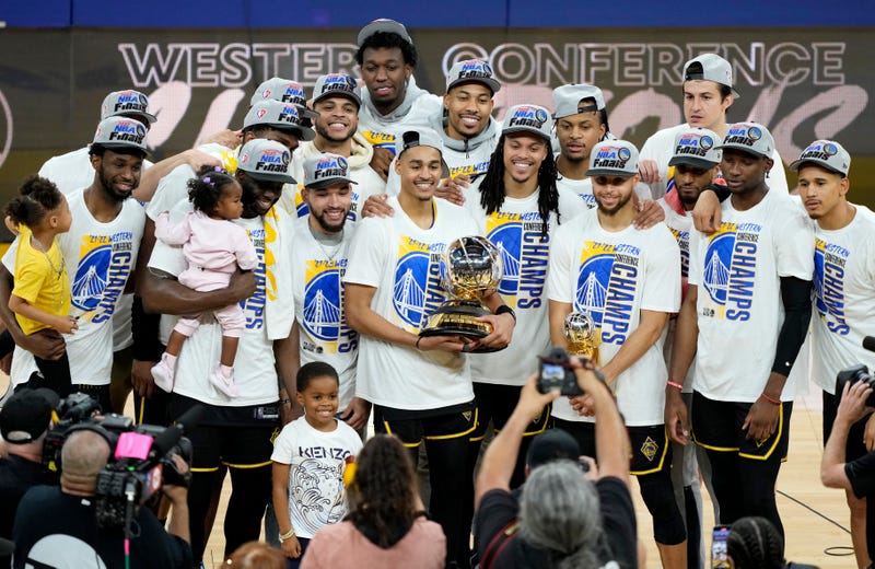The Golden State Warriors hold the Western Conference Champion trophy after the 120-110 win against the Dallas Mavericks in Game Five of the 2022 NBA Playoffs Western Conference Finals at Chase Center on May 26, 2022 in San Francisco, California.