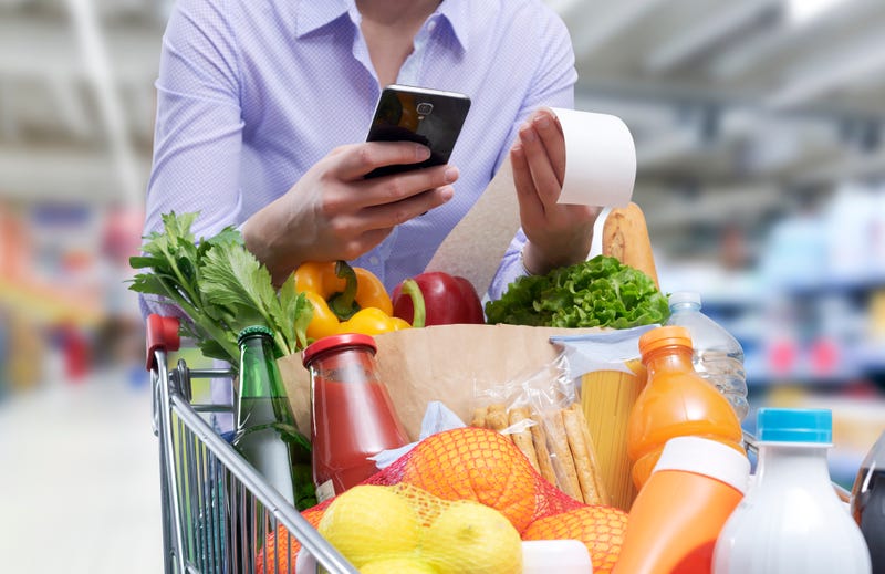 Stock image of person looking at grocery store bill