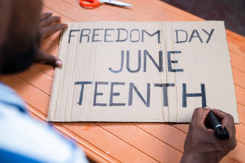 Activist preparing freedom day Juneteenth sign board for marching.