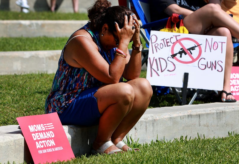 Tirza Clarke listens as the names of victims of recent mass shootings are read aloud during a vigil in Sunrise, Florida, 5/28/22. Moms Demand Action held the vigil to mourn the victims of mass shootings in Buffalo, NY, and Uvalde, TX.