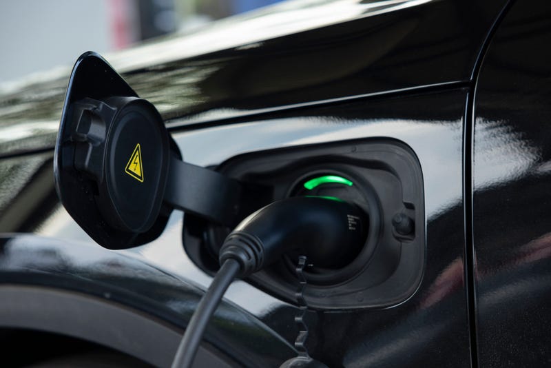 Charging the vehicle at a car park or fuel station. electric vehicle charging station. Pure energy is environmentally friendly of the future world. 