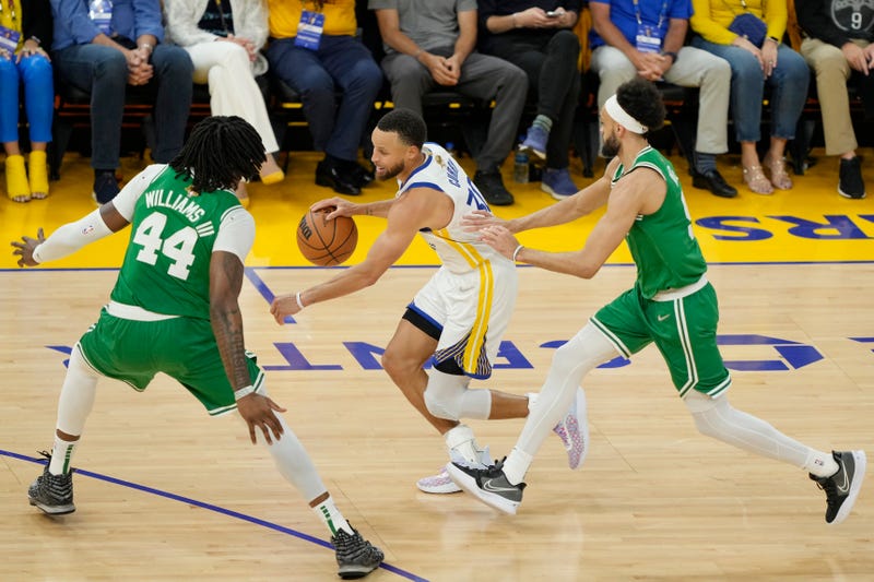 Stephen Curry #30 of the Golden State Warriors dribbles against Robert Williams III #44 and Derrick White #9 of the Boston Celtics during the second quarter in Game One of the 2022 NBA Finals at Chase Center on June 02, 2022 in San Francisco, California.