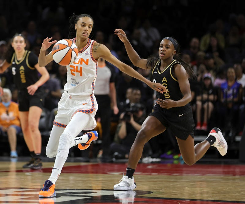 DeWanna Bonner #24 of the Connecticut Sun chases down a loose ball under pressure from Jackie Young #0 of the Las Vegas Aces during their game at Michelob ULTRA Arena on June 02, 2022 in Las Vegas, Nevada. The Sun defeated the Aces 97-90.