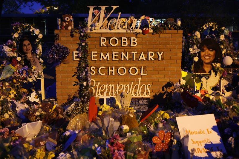 UVALDE, TEXAS - JUNE 03: Flowers and photographs are seen at a memorial dedicated to the victims of the mass shooting at Robb Elementary School on June 3, 2022 in Uvalde, Texas. 19 students and two teachers were killed on May 24 after an 18-year-old gunman opened fire inside the school. Wakes and funerals for the 21 victims are scheduled throughout the week. (Photo by Alex Wong/Getty Images)