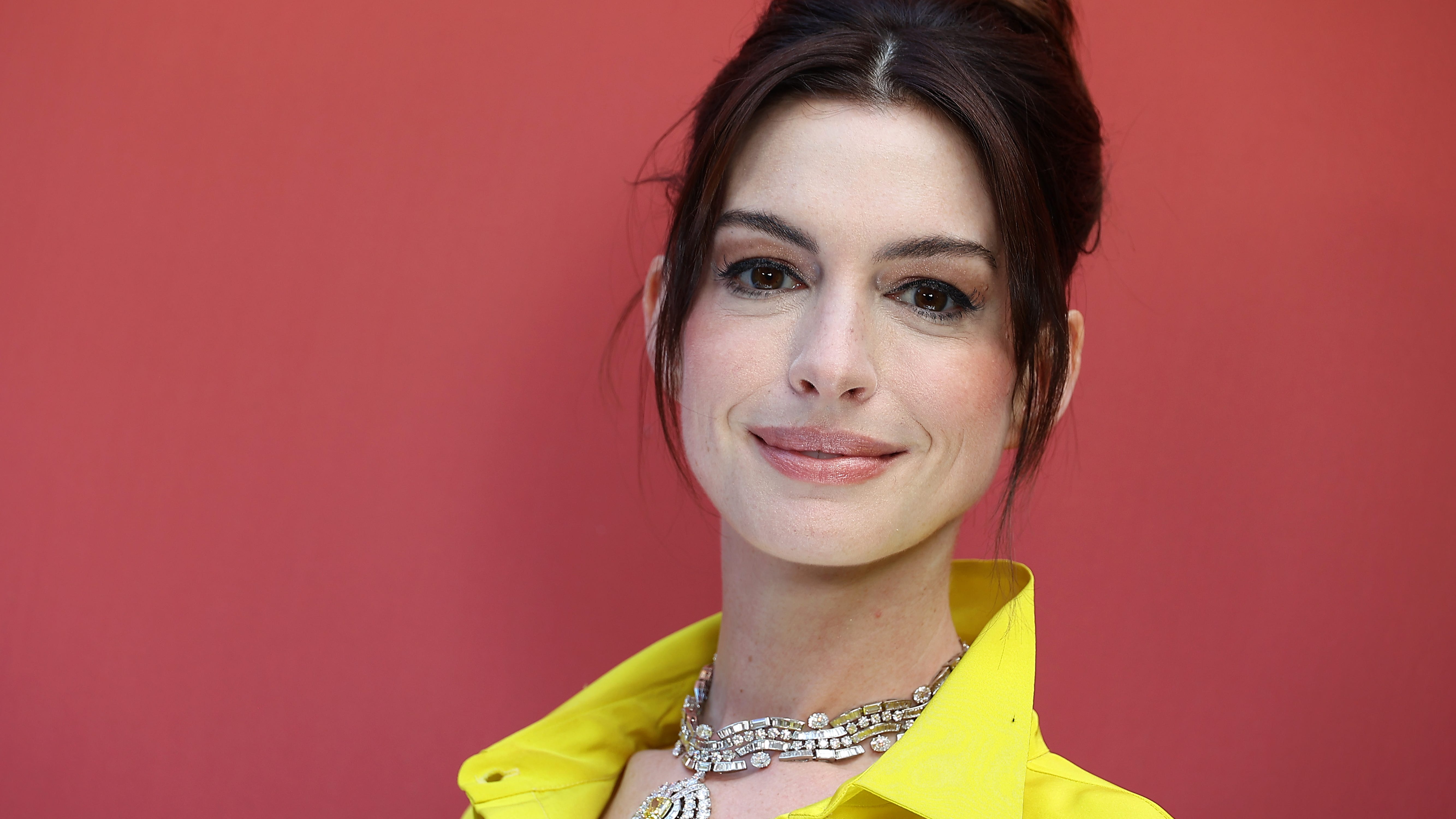 Anne Hathaway goes bold with big blazer and short skirt