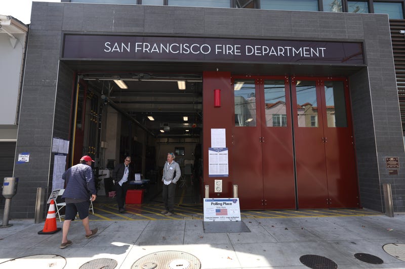 A voter is greeted by poll workers as he arrives at a polling station at San Francisco fire station 16 on June 07, 2022 in San Francisco. California.