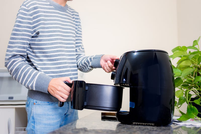 Man using air fryer. 