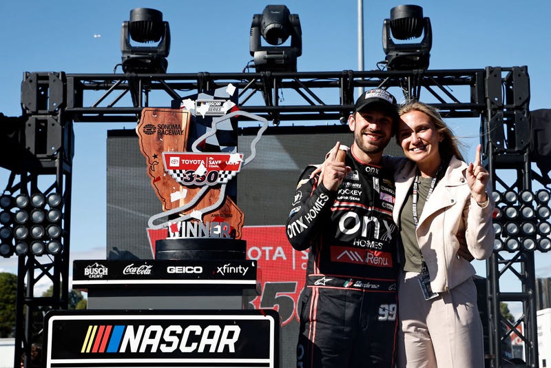 Daniel Suarez, driver of the #99 Onx Homes/Renu Chevrolet, and Julia Piquet celebrate in victory lane after winning the NASCAR Cup Series Toyota/Save Mart 350 at Sonoma Raceway on June 12, 2022 in Sonoma, California.