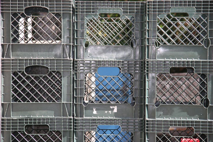 Stacks of grey milk crates