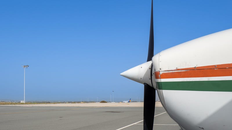 Light aircraft on a spacious airport apron - stock photo