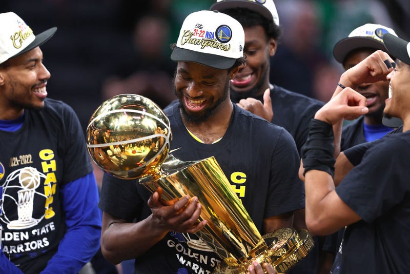 Andrew Wiggins of the Golden State Warriors celebrates with the Larry O'Brien Championship Trophy after defeating the Boston Celtics 103-90 in Game Six of the 2022 NBA Finals at TD Garden on June 16, 2022 in Boston, Massachusetts.