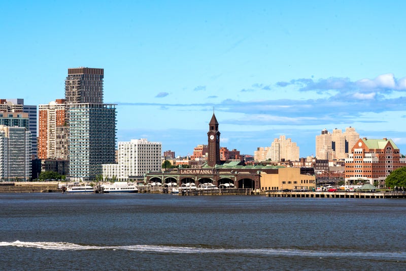 A landscape view of the historic Hoboken Terminal, NY Waterway-operated ferries and the skyline of Hoboken's waterfront.