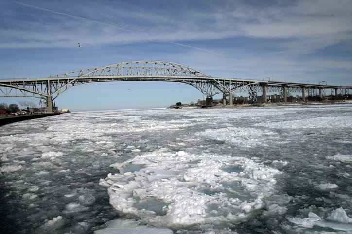The U.S. and Canadian Coast Guard work together to break up an ice jam in the St. Clair River