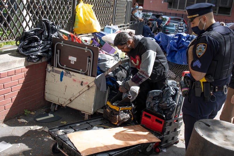 The New York City Department of Sanitation, backed up by police officers, conduct enforced removals of homeless encampments on June 23, 2022 in Chinatown.