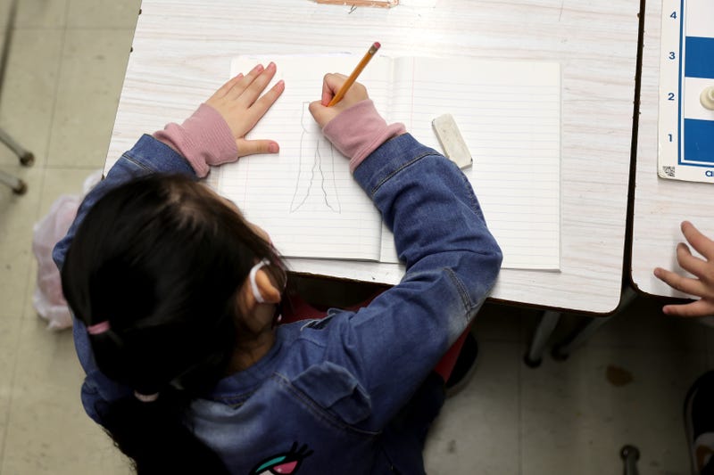A student draws on a piece of paper during the second to last day of school as New York City public schools prepare to wrap up the year at Yung Wing School P.S. 124 on June 24, 2022 in New York City. Approximately 75% of NYC public schools enrolled fewer students for the 2021/2022 school year due to the pandemic.
